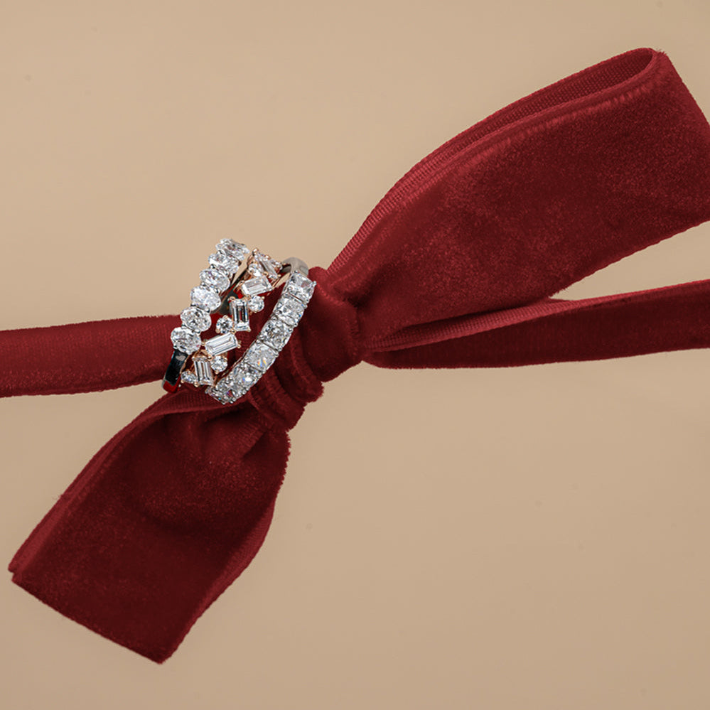 Two diamond rings on a red ribbon against a beige background with 'sol et terre' branding.
