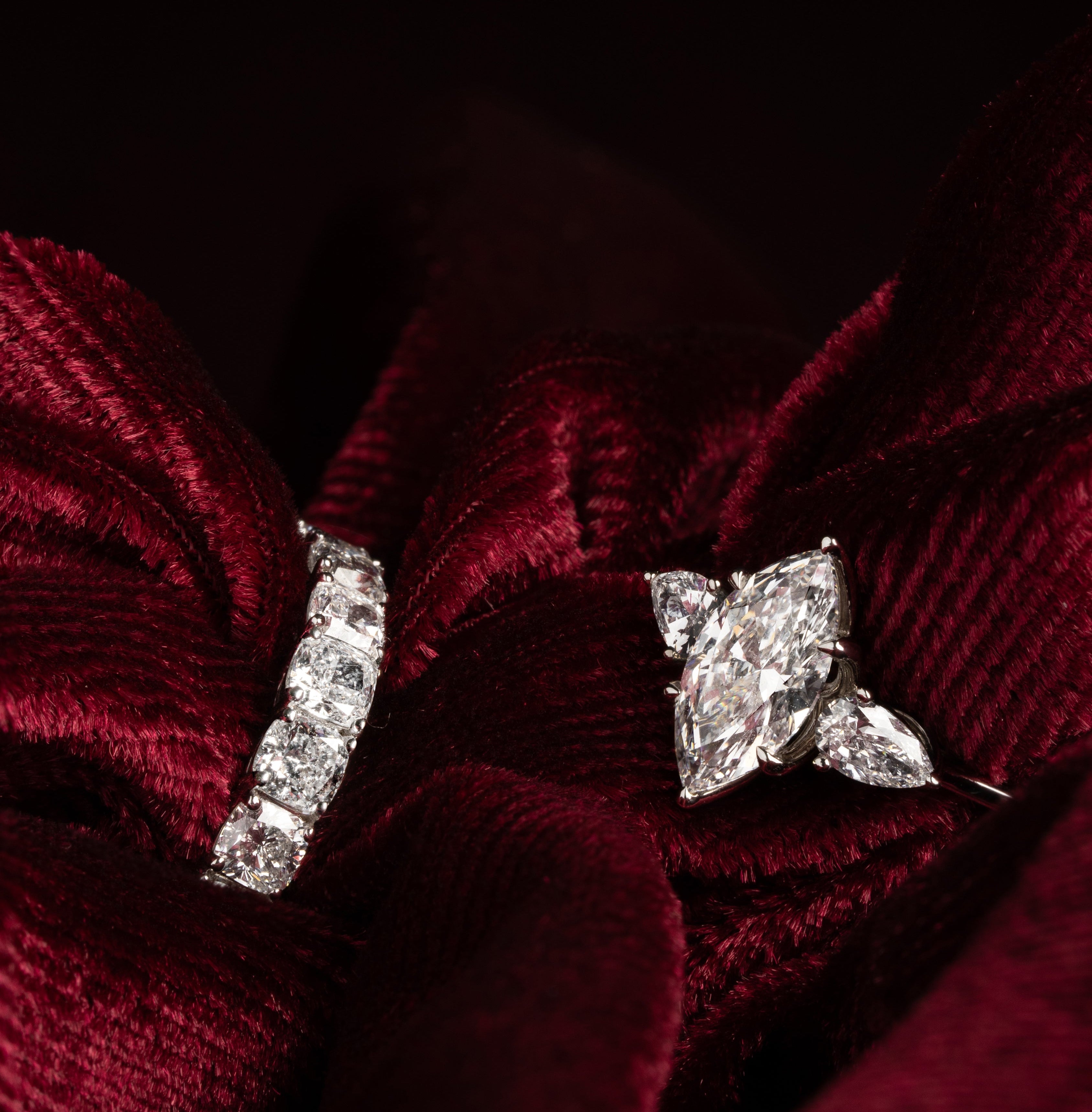 Diamond earrings on a red fabric background