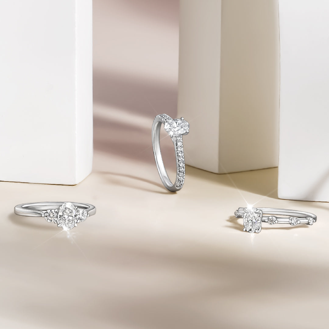 Three White Gold and Diamond rings with pave diamond accents on a soft beige background
