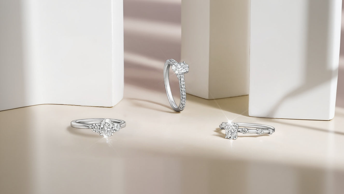 Three White Gold and Diamond rings with pave diamond accents on a soft beige background